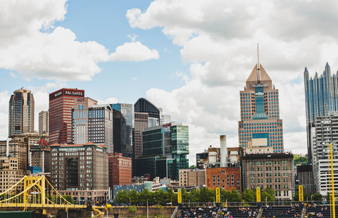 city buildings under white clouds during daytime