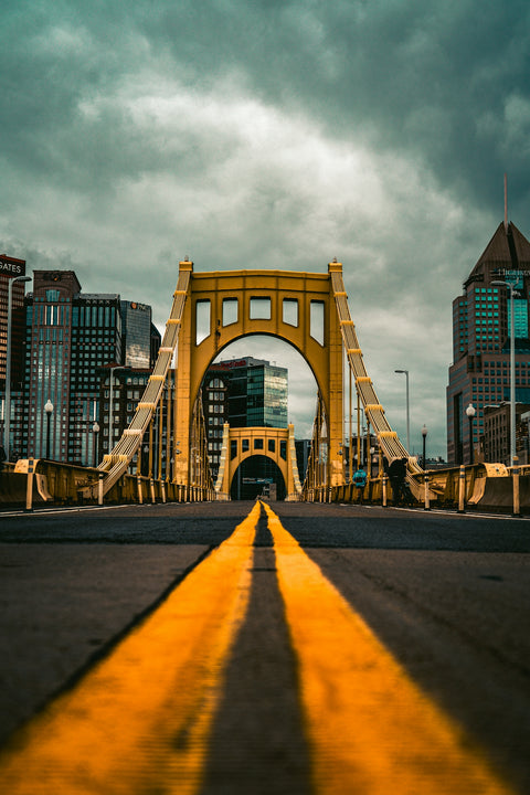 a yellow line on the road leading to a bridge