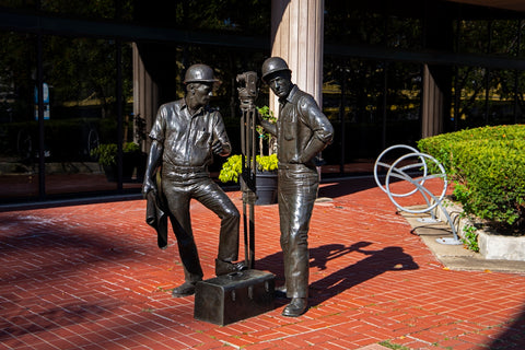 a statue of two men sitting next to each other