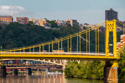 a train on a bridge over a river