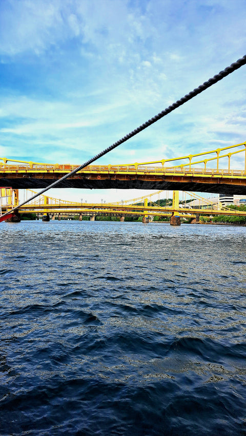 a man riding a surfboard on top of a body of water
