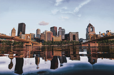 a view of a city with a bridge and a body of water