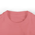 Close-up of coral pink infant T-shirt neckline, soft and breathable for toddler wear.