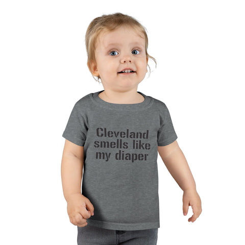 Toddler in dark gray T-shirt with black text 'Cleveland smells like my diaper,' a fun and cheeky kids clothing option.