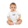 Baby in white onesie with 'Cleveland smells like my diaper' print, playful and comfy infant outfit.