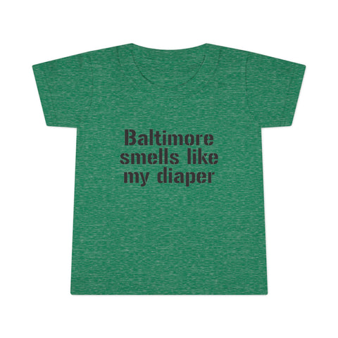 Heather green toddler T-shirt with black 'Baltimore smells like my diaper' text, a fun and sarcastic kidswear piece.