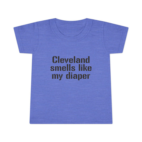 Heather blue toddler T-shirt with black text 'Cleveland smells like my diaper,' a playful and trendy kids clothing piece.