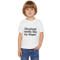 Toddler wearing white Cleveland Smells Like My Diaper t-shirt, a fun and comfy cotton tee for kids' casual fashion.
