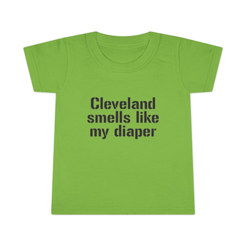 Green toddler T-shirt with black text 'Cleveland smells like my diaper,' perfect for humorous and casual kids clothing collections.