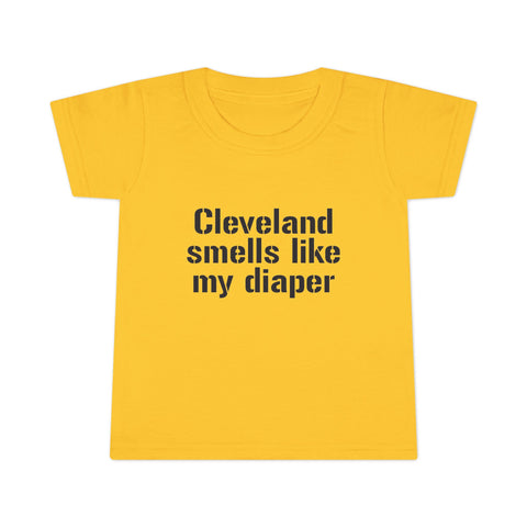 Bright yellow toddler T-shirt featuring the funny slogan 'Cleveland smells like my diaper' in bold black print, ideal for playful kids fashion.