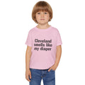 Toddler wearing pink Cleveland Smells Like My Diaper t-shirt, a fun and soft cotton tee for humorous children's fashion.