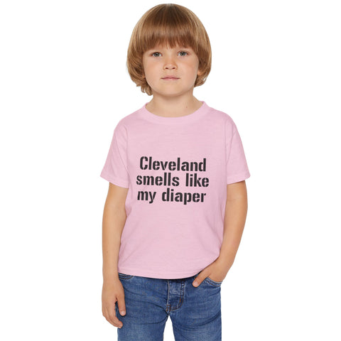 Toddler wearing pink Cleveland Smells Like My Diaper t-shirt, a fun and soft cotton tee for humorous children's fashion.