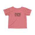 Coral pink Cleveland Smells Like My Diaper infant t-shirt with black text, humorous and soft baby clothing.