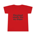 Red toddler T-shirt with bold black text 'Cleveland smells like my diaper,' a funny and eye-catching kidswear item.