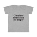Gray toddler T-shirt with bold black text reading 'Cleveland smells like my diaper' in a humorous design for kids clothes.