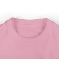 Close-up of pink infant T-shirt collar, made from soft cotton for baby clothing comfort.