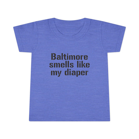 Heather blue toddler T-shirt with bold black 'Baltimore smells like my diaper' lettering, a quirky kids clothing item.